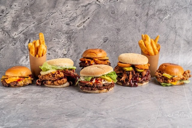 Grayze smash burgers and chips photographed on a stone backdrop